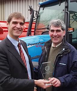 Landini UK sales director Simeone Morra (left) presents the 'Dealer of the Year' award to Tony Newsham of T H Horn, the farm machinery business based at Cabus near Garstang, Lancs.