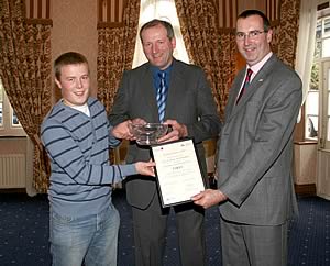Sion Roberts (L) receives rosebowl for first place from Jonathan Davies, NMR (R) and George Collins, Alta