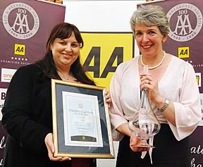 Val Leeming, right, receives her AA’s national tourism awards from presenter Gioranna Grossi.