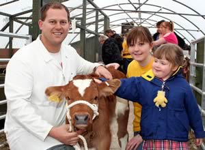 Tintin takes a bow. Pictured with the calf are, from left, Keelham Hall Farm Shop’s co-owner James Robertshaw, Aire Valley YFC’s Charlotte Ormondroyd and young visitor Rose Cameron.