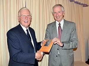 John Fox (left) is presented with a plaque from Jonathan Bomford. 