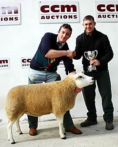 Mark Keighley with his Skipton Texel pedigree female winter shearling ewe champion, joined by judge Mark Ireland.