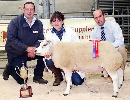 Karen Shuttleworth with her CCM Skipton supreme champion Beltex shearling ram, joined by judge and buyer Simon Blandford, right, and co-sponsor Robert Garth, of JG Animal Health.