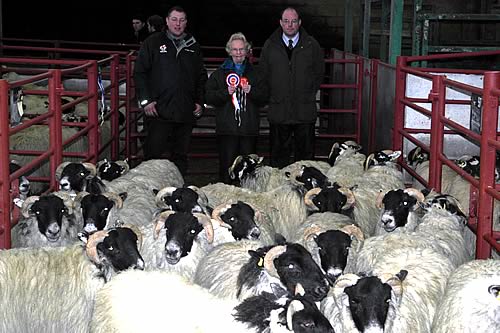 Champion pen of Blackfaced Hoggs with L to R, Ross Pattinson of Agri-Lloyd, Margaret Fergusson of Barlaes and judge Andrew Dawson