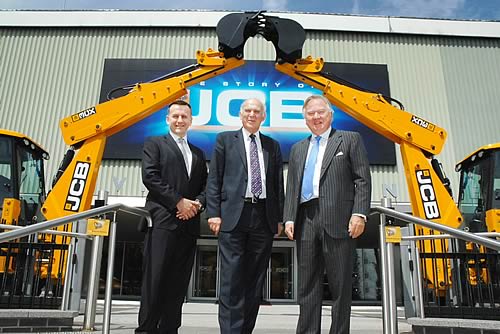 Business Secretary Dr Vince Cable (centre) is welcomed to JCB by Chairman Lord Bamford (right) and CEO Graeme Macdonald.