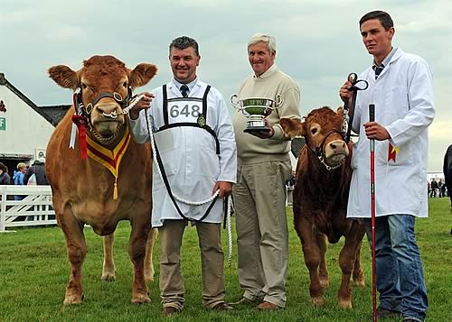 l-r Stockman Dougie McBeath, with the Supreme Beef Champion, Brockhurst Bolshoi with calf at foot , owner Doug Mash, and stockman, Ben Bellew
