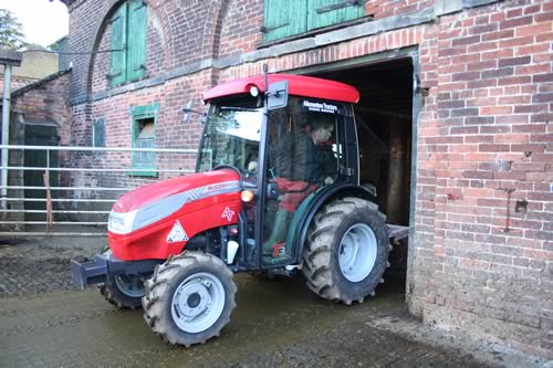 Young dairy farmer Chris Yates gets to clean up after his cows on a new McCormick compact tractor with heater and Bluetooth music – making the job a lot pleasanter than on his old open-air tractor!