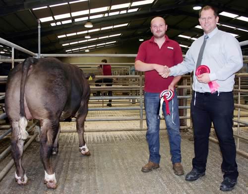 Skipton’s August prime cattle champion is pictured with exhibitor Paul Baines, joined by judge James Roberthshaw, of Keelham Farm Shop.