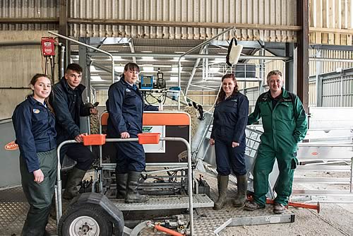 Newton Rigg College Level 3 agriculture students, Imogen Bell, 16, of Haydon Bridge, Northumberland, Laura Elliott, 17, of Ellonby, Penrith, Ebony Telford, 17, of Roadhead, Carlisle and Ollie Raine, Kirkoswald, Penrith aged 17 with Matt Bagley, Head of Agriculture working with some of the new technology - a Ritchie Combi Clamp which enables sheep scanning to be undertaken.
