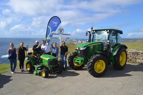 We made it! (Left to right) Kathryn Maxfield, Joanne Gregory, Andy Maxfield, Chris Meacock, Kaitlyn Maxfield and Becca Watson at Land’s End with the X750 lawn tractor and one of its larger cousins, a 5100M supplied by local John Deere dealer Cornwall Farm Machinery.